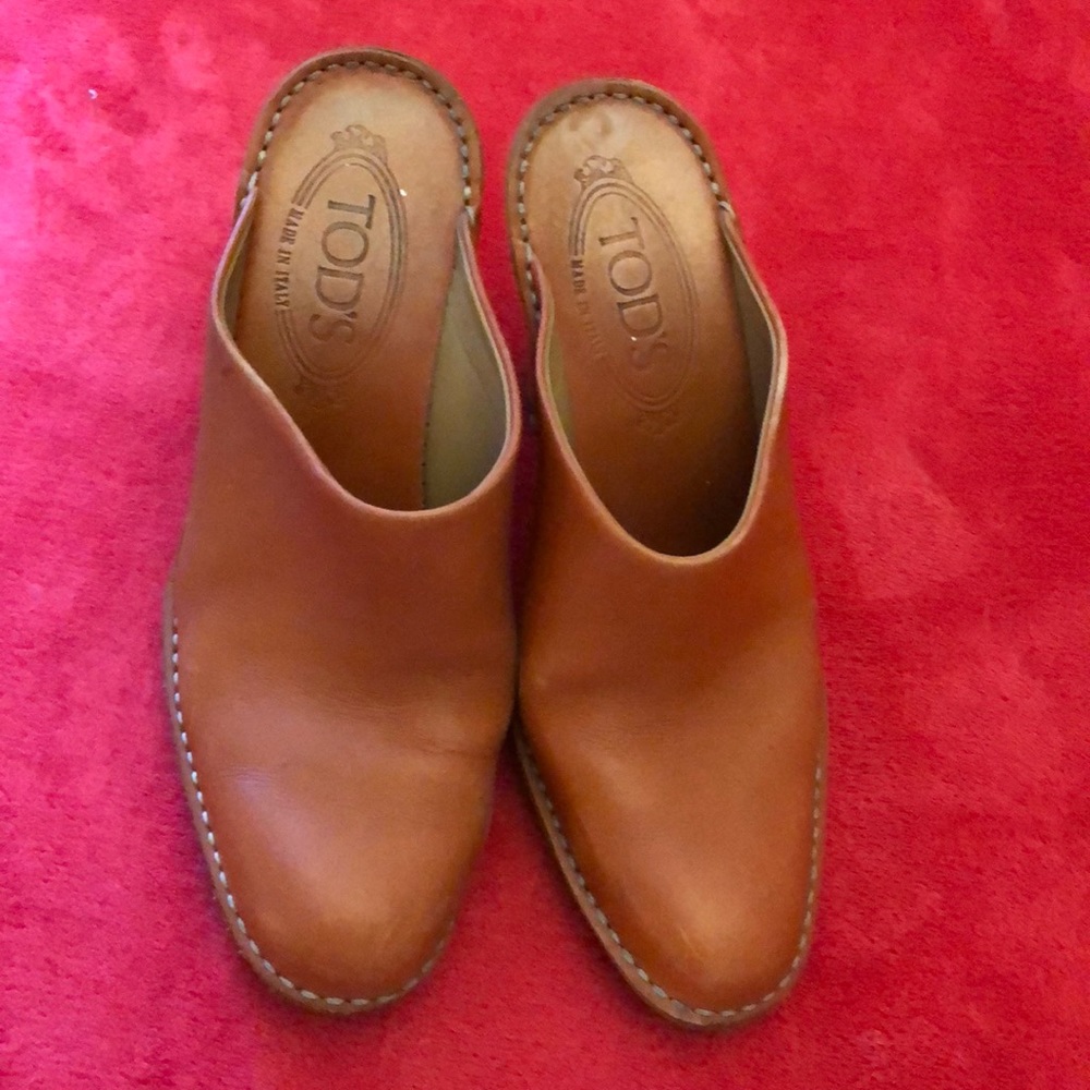 Tods mules in orange with top stitching.